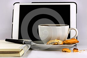 Cup of coffee,tablet computer,book and pen