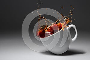 Cup of coffee or tea fell illuminated surface