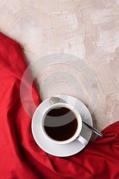 Cup of coffee or tea red napkin concrete background