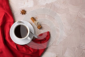 Cup of coffee or tea red napkin spices concrete background