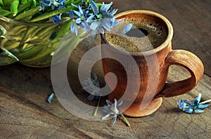 Cup of coffee and tender spring blue flowers. snowdrop flowers and morning coffee. bluebell flowers. copy space