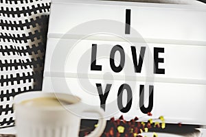 Cup of coffee and text I love you in a lightbox