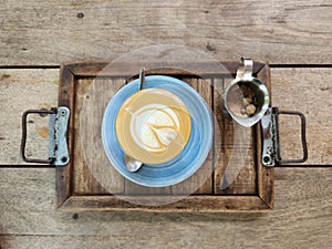 Cup of coffee in top view wooden table background