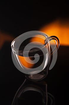 A cup of coffee in transparent glass shot in studio