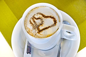 Cup of coffee with two hearts. It s symbol of Love in foam