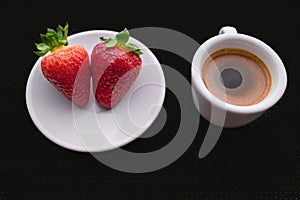 Cup of coffee and two strawberries