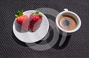 Cup of coffee and two strawberries
