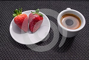 Cup of coffee and two strawberries