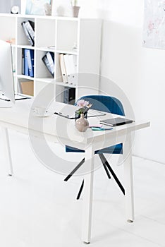 Cup of coffee, vase and clipboard on table