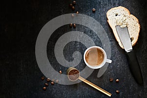 Cup of coffee, wheat bread, butter and coffee beans
