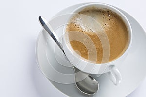 Cup of coffee on a white plate on white background