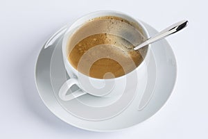 Cup of coffee on a white plate on white background