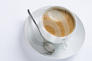 Cup of coffee on a white plate on white background