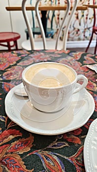 A cup of coffee on white saucer