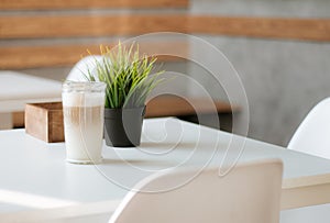 Cup of coffee on a white table in a cafe