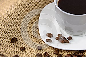 Cup of coffee wirh roasted beans