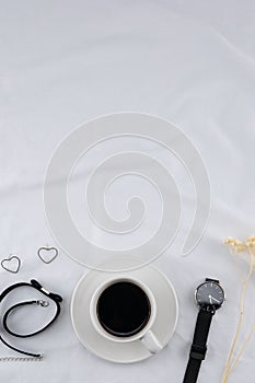 A cup of coffee with woman accessories