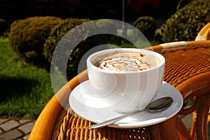 cup of cream coffee on wood table