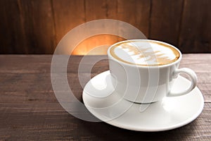 A cup of coffee on wooden background