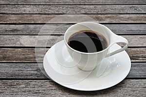 Cup of coffee on wooden background and copy space