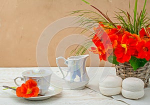 Cup of coffee on wooden background  and nasturtium edable flowers