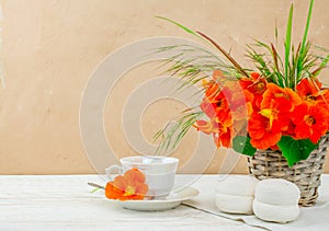 cup of coffee on wooden background  and nasturtium edable flowers