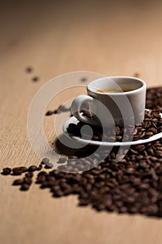 Cup of coffee on a wooden table with coffee beans photo