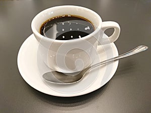 Cup of coffee on wooden table photo