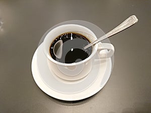 Cup of coffee on wooden table photo