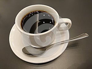 Cup of coffee on wooden table photo