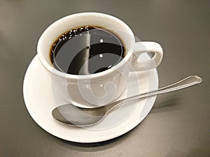 Cup of coffee on wooden table photo