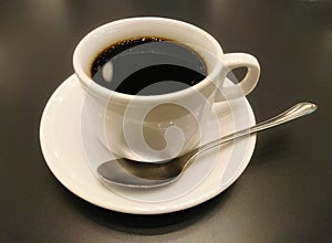 Cup of coffee on wooden table photo