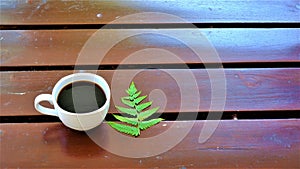 A cup of coffee on wooden table photo