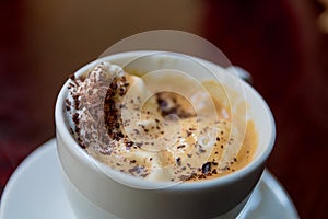 Cup of coffee on the wooden table. with an ice creame and grated chocolate. Top view