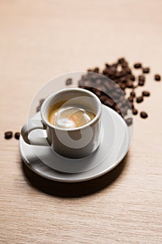 Cup of coffee on a wooden table with natural coffee photo