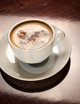 Cup of coffee on a wooden table in restaurant