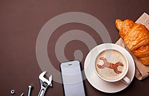 Cup of coffee with wrench on the foam. I like coffee break with croissant. Repair service concept