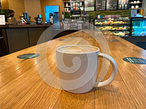 Cup of Creamy Coffee in Starbucks photo