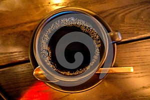 Cup of dark coffee espresso on wooden table