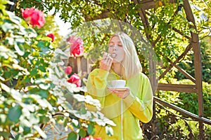 Cup of delight. Enjoy delicious creamy cappuccino in blooming garden. Girl drink gourmet cappuccino. Woman enjoy divine