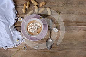 cup with drink coffee cappuccino and foam in brain form on old vintage wooden table, caffeine improves functioning of human brain