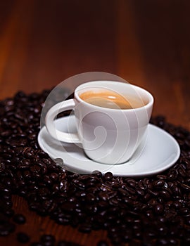 Cup Of Espresso And Beans On A Wooden Table