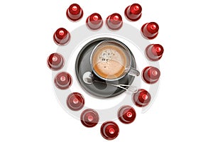 A cup of espresso coffee capsules