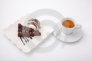 Cup of espresso coffee with piece of chocolate cake and ice cream