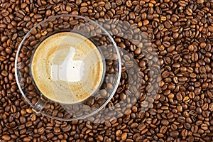 Cup of espresso with like sign on coffee foam on coffee beans background. With copy space