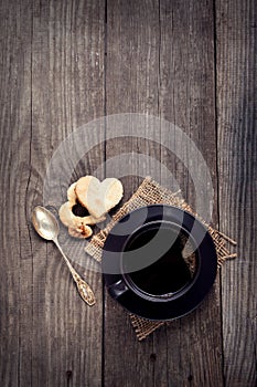 Cup of espresso on the table in a vintage Valentine`s Day cookie