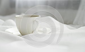 Cup on fabic white background photo image