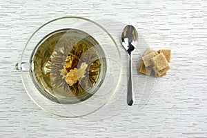 Cup of flowering tea with sugar