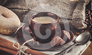 Cup fragrant hot coffee with bean chocolate