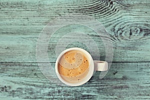 Cup of fresh aroma coffee on vintage blue table